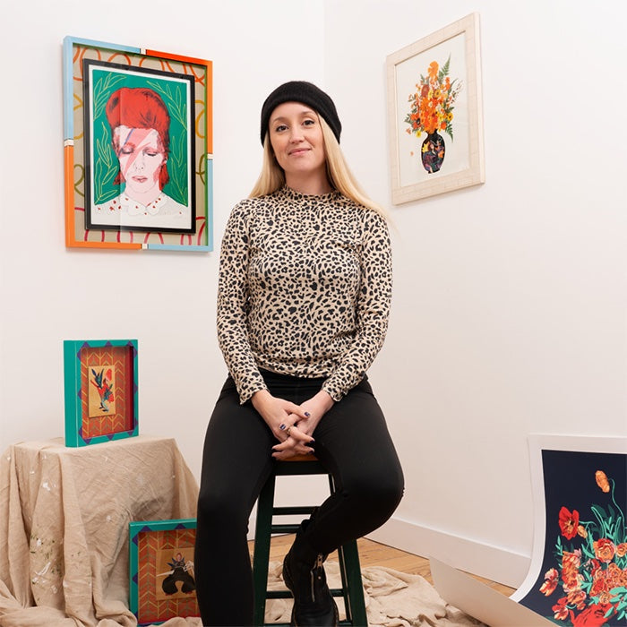 Hannah Gilson sat in her studio surrounded by her artwork